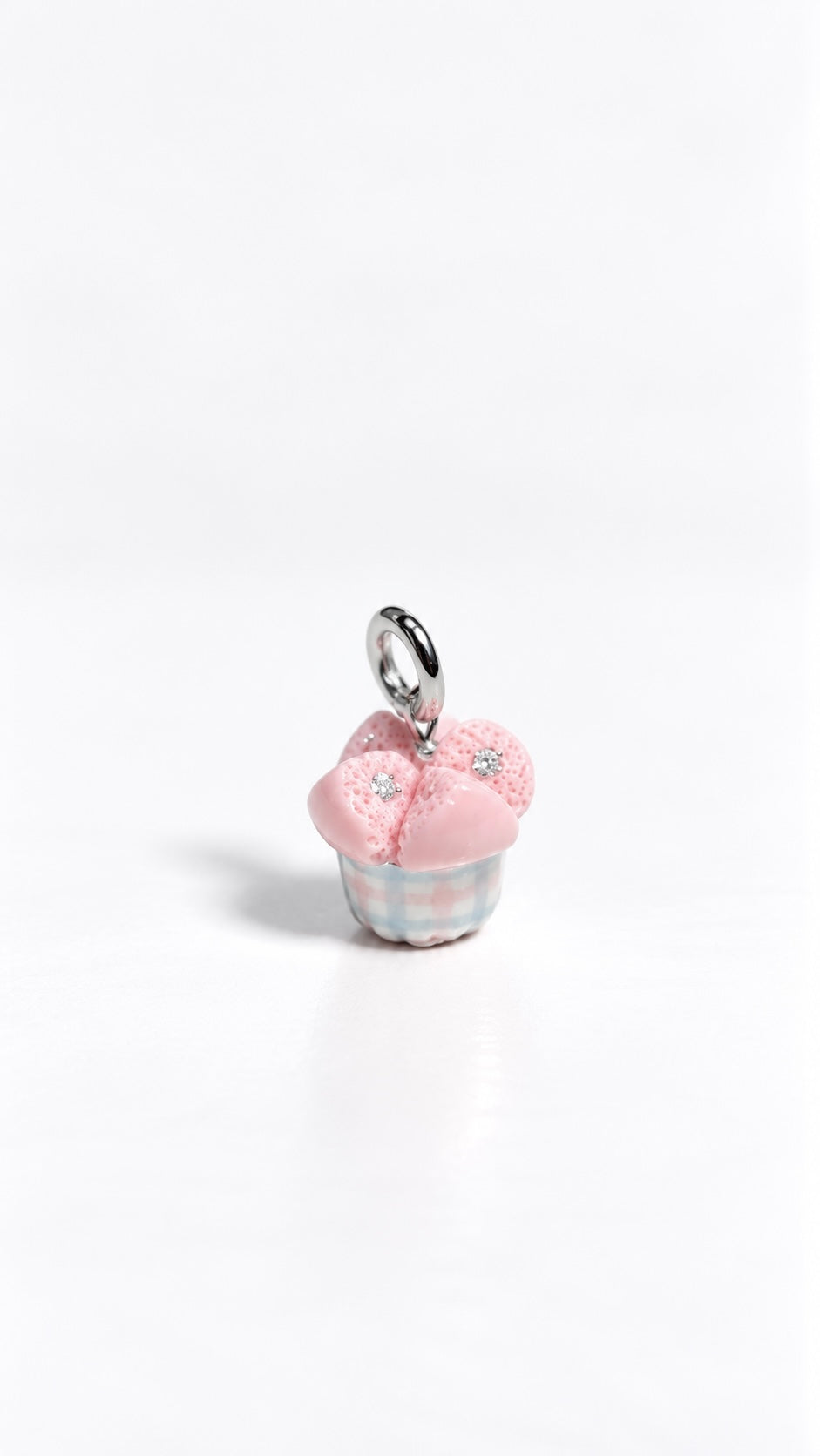 Close-up of eight 2 mm moissanites embedded in the petals of a gingham huat kueh polymer clay charm