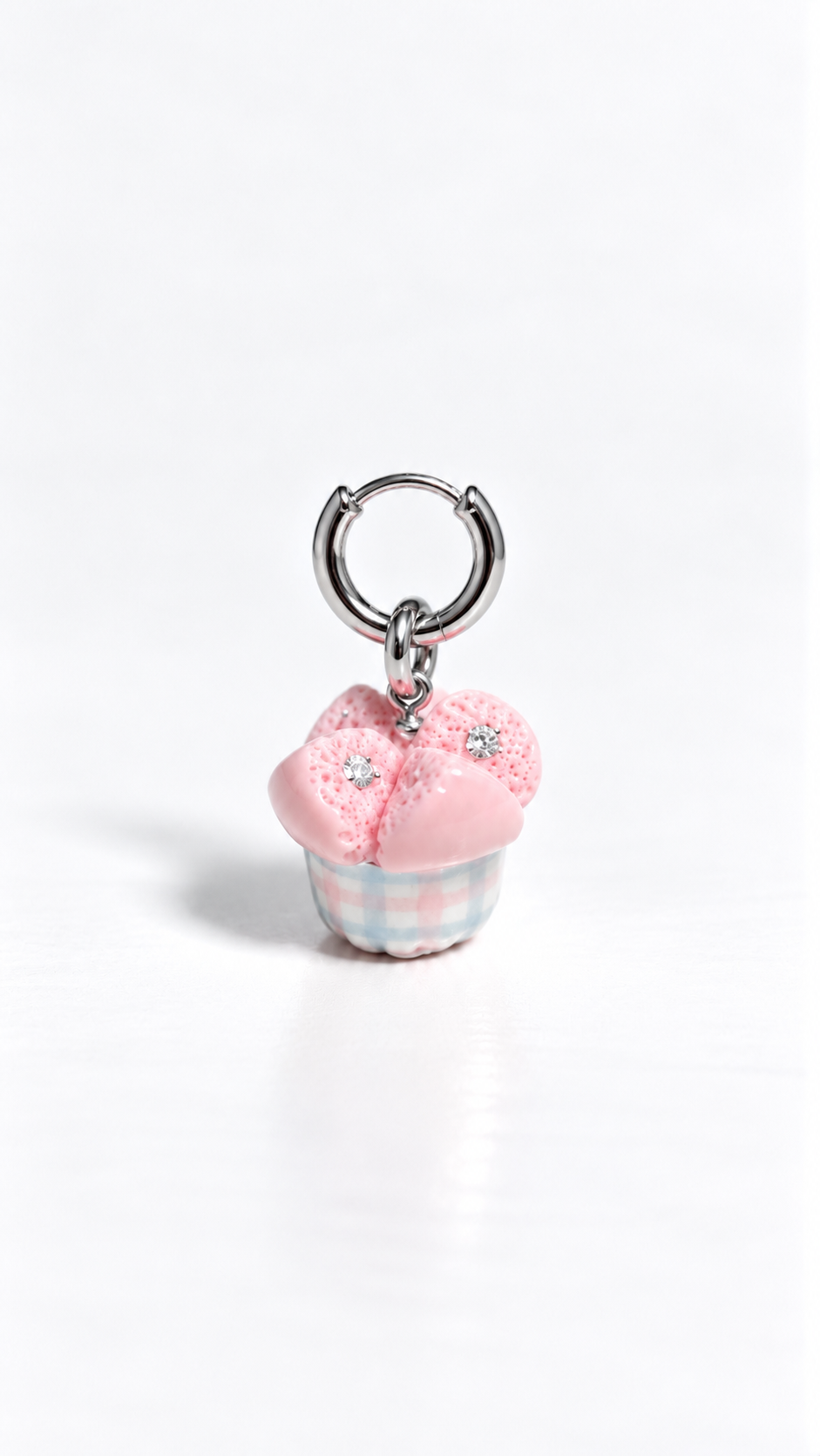 Huat kueh gingham charm with moissanites clipped onto a hoop earring, miniature food earrings